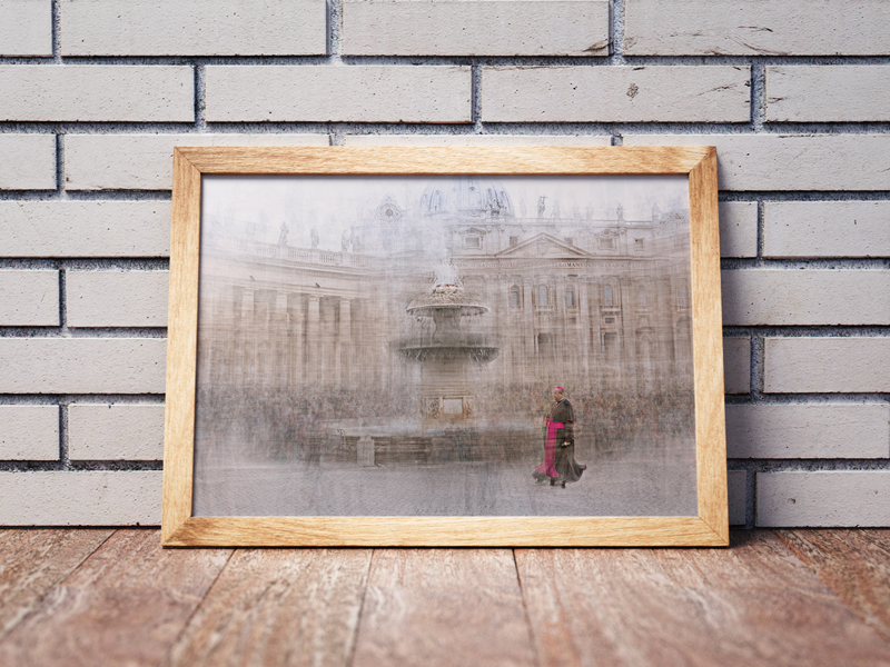 a framed picture of a monsignore walking in piazza del vaticano in rome is on the floor