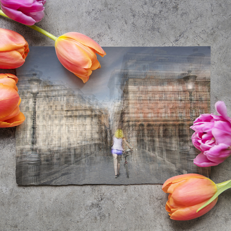 a fine art photography print on a table next to some flowers